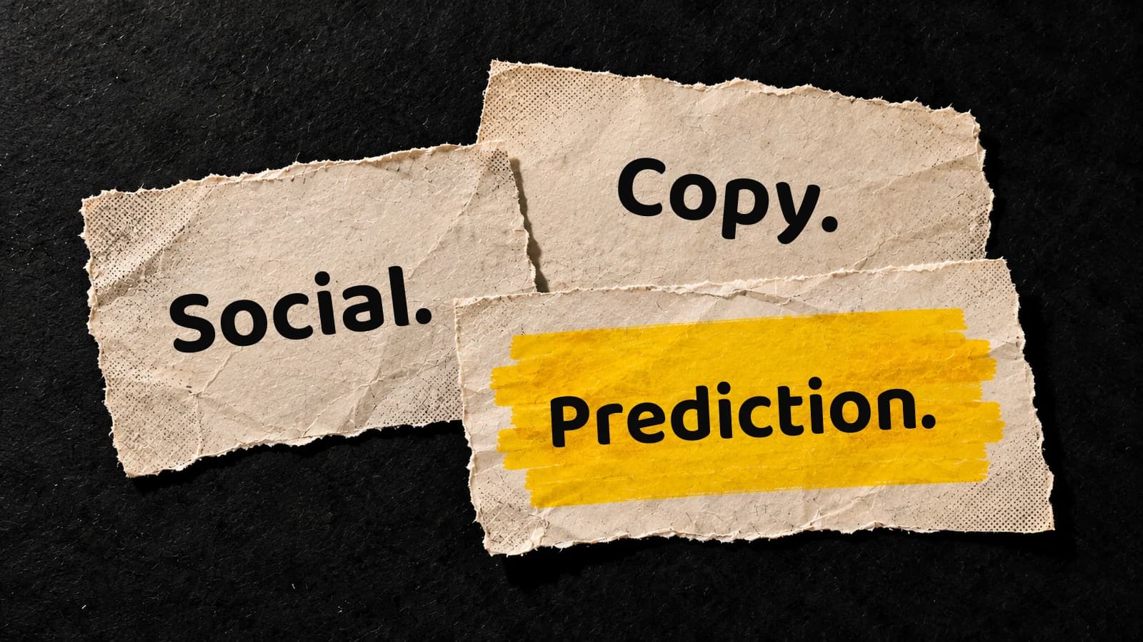 Three overlapping cream paper notes on charcoal read “Social.”, “Copy.” and “Prediction.”, with yellow marker behind “Prediction.”